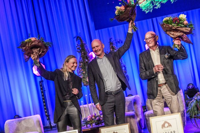 three people with bouquets suspended in the air